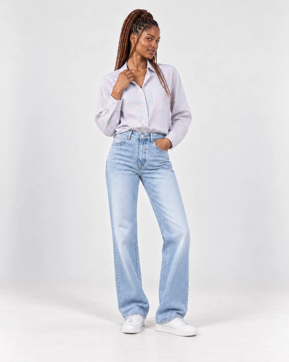 Ready-made model Zola in a pale striped shirt and light jeans, glancing back over her shoulder